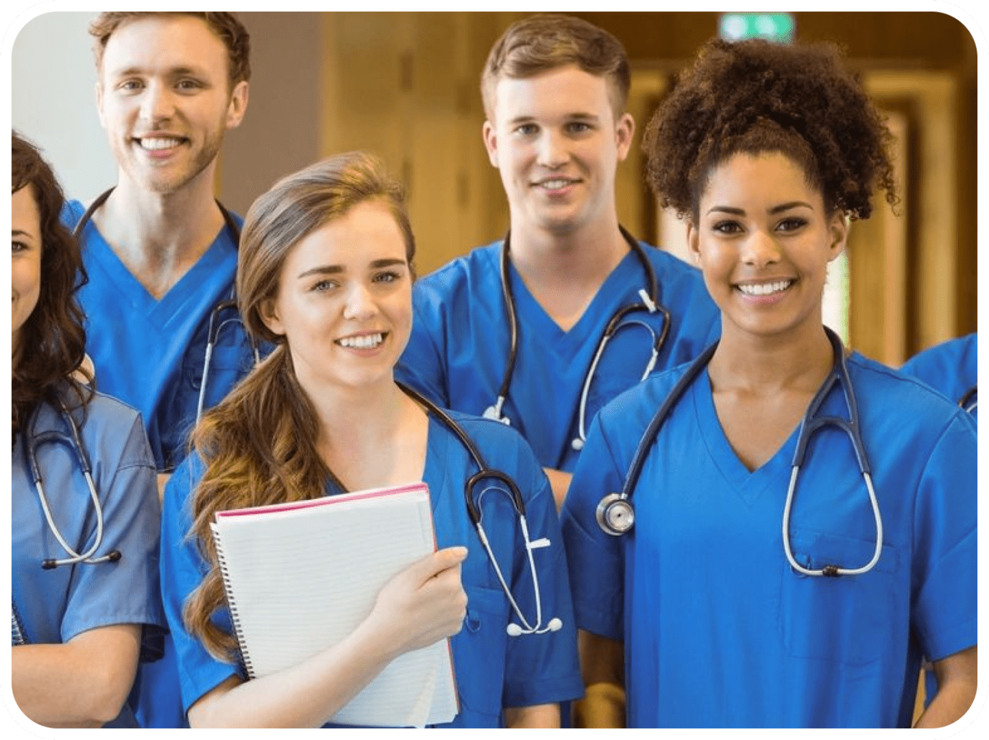fm=f_OpGgmjJ A group of doctors standing together in blue scrubs.