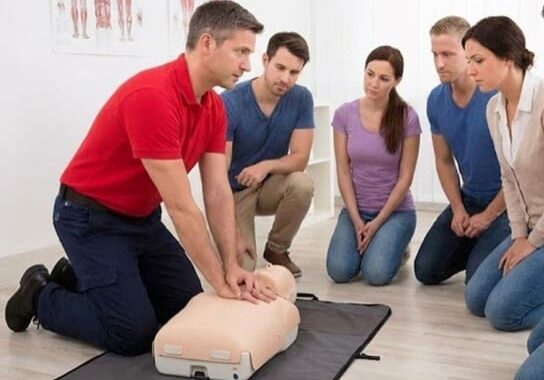 Instructor demonstrating CPR on training mannequin